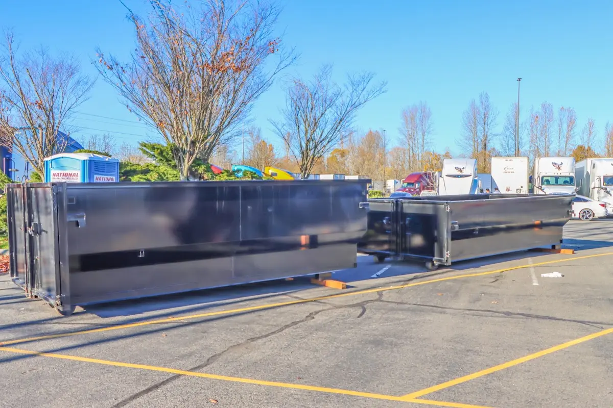 Professional dumpster rental service with roll-off container on residential driveway in St. Peters